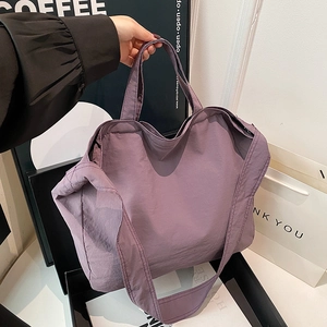 Minimalist purple nylon tote bag with textured finish, handheld for daily commute use