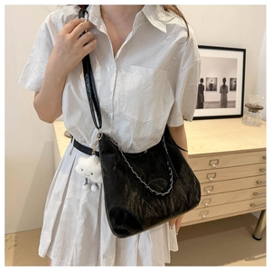 Close-up of black pleated texture shoulder bag with silver chain and cloud charm