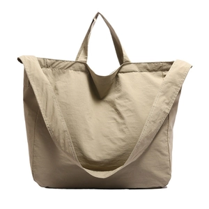 Minimalist nylon tote bag in khaki finish with dual handles and adjustable shoulder strap