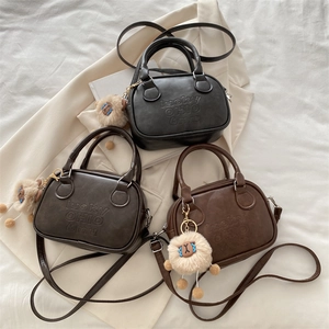 Three minimalist retro leather handbags in black, dark brown, and brown with cute charms