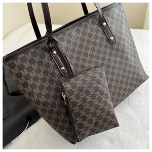 Detail of a brown tote bag with M-pattern texture and a matching small zipper pouch