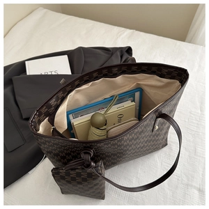 Large tote bag interior showing capacity for tablets, books, and accessories