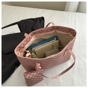 Pink tote bag interior showing large capacity with books, tablet, and matching pouch