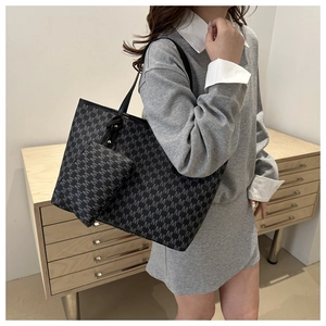 Detailed view of large printed tote bag and matching small pouch on model shoulder