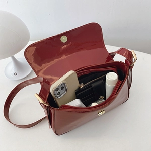 Glossy burgundy patent leather shoulder bag with spacious interior and magnetic closure