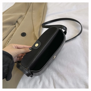 Detailed view of the black leather saddle bag interior with a secure magnetic closure