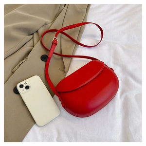 Chic red semi-circle saddle bag with smooth leather finish and metal buckle detail