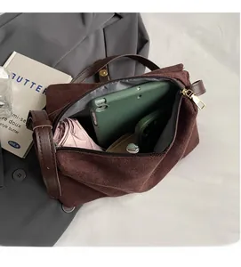 Detail view of brown vintage messenger bag with spacious interior for tablets and umbrellas