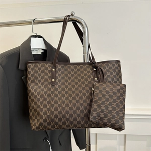 Deep brown tote bag set with M-pattern print and matching small pouch on a blazer