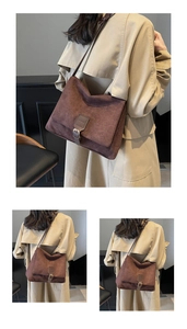 Detail of vintage dark brown frosted suede shoulder bag featuring a stylish metal buckle