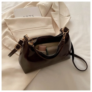 Interior view of deep brown crescent bag showing space for cosmetics and small wallet