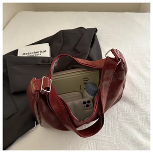 Detail of spacious dark red vintage tote bag interior showing daily storage capacity
