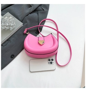 Detailed view of magenta moon saddle bag with golden heart buckle and fine leather strap