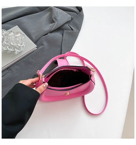 Internal view of pink saddle bag showing spacious main compartment and zipper pocket