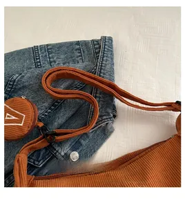 Detail of brown corduroy tote bag showing fabric texture and shoulder strap connection