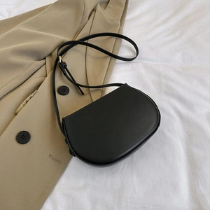 Minimalist black saddle bag in matte PU leather with adjustable strap for daily wear