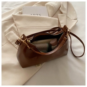 Interior view of brown faux leather underarm bag showing spacious storage for daily items