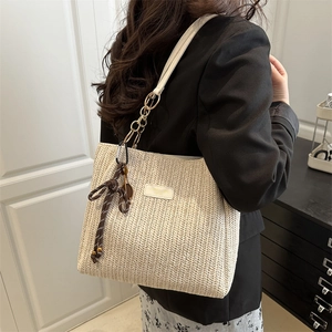 Chic cream straw tote bag with white leather straps and golden chain accents