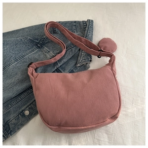 Pink corduroy crossbody bag with adjustable strap and matching small round coin purse