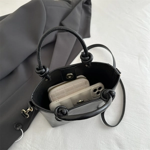 Sac seau noir minimaliste avec poignée à nœud en corde et bandoulière réglable