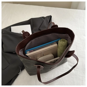 Interior view of large grey canvas tote bag showing spacious capacity and zipper closure