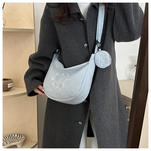 Light blue corduroy crossbody bag with round pattern and a small matching coin purse