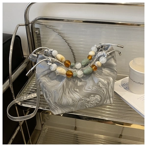 Chic silver marble pattern bucket bag with pleated design and colorful beads on the handle