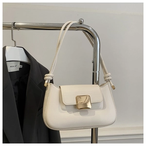 Detail of white PU leather underarm bag with large square gold buckle and rope strap