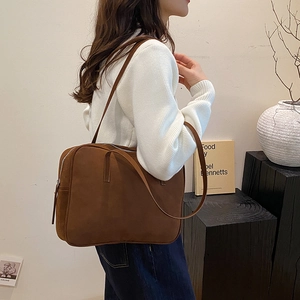 Brown suede tote bag side view on shoulder showing minimalist rectangular design