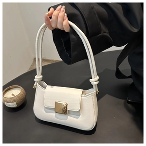 Detail of minimalist beige PU leather shoulder bag with decorative gold square metal buckle