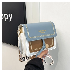Detail of tricolor crossbody bag with wide floral strap and elegant gold embossed logo