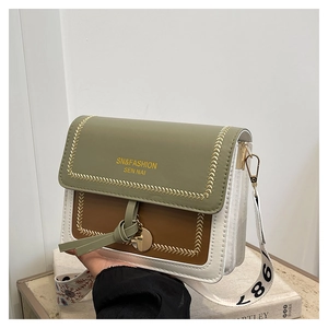 Detail of tricolor crossbody bag with V-shaped stitching, tassels and printed strap