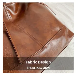 Close-up of vintage dark brown oil wax leather texture and neat stitching detail