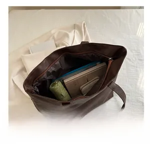 Interior view showing the large capacity of the dark brown leather tote bag