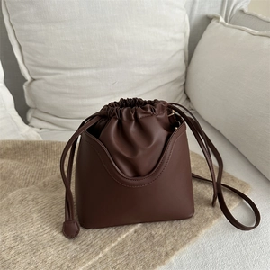 Vintage dark brown drawstring bucket bag with structured U-shape and soft inner pocket