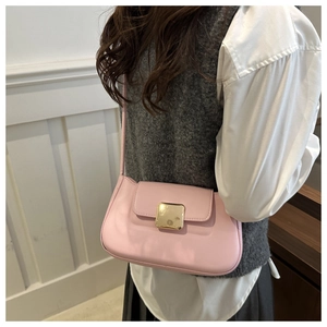 Close-up of pink leather crossbody bag featuring a classic gold square metal buckle