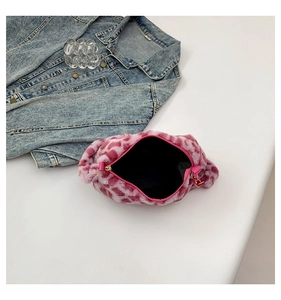 Gros plan du sac à main en peluche rose et blanc avec fermeture éclair dorée