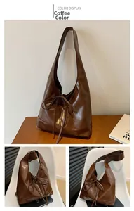 Detailed macro view of the dark brown hobo bag with elegant bow tie strap details