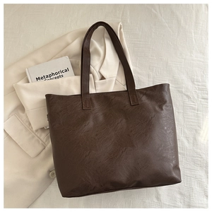 Close-up of deep brown vintage PU leather tote bag with reinforced handles for work