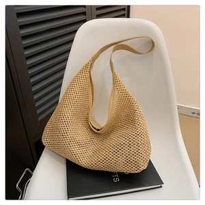 Detailed view of large capacity woven tote bag with PU strap on a white chair