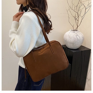 Minimalist large brown tote bag shown on model for a premium commuter aesthetic