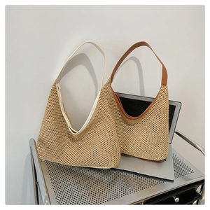 Detail of woven straw tote bags with faux leather trim and large capacity storage