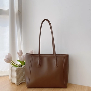 Elegant brown faux leather tote bag with long shoulder straps for daily commuting
