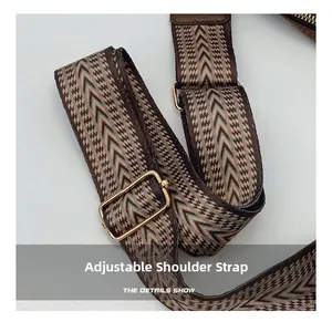 Macro detail of adjustable woven shoulder strap with geometric pattern and gold buckle