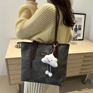 Large dark grey canvas tote bag with brown leather handles and cloud charm detail