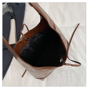 Macro view of the large capacity tote bag interior with magnetic closure and dark lining
