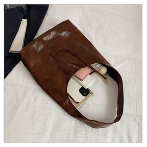 Interior view showing the large capacity storage for daily essentials in brown tote bag