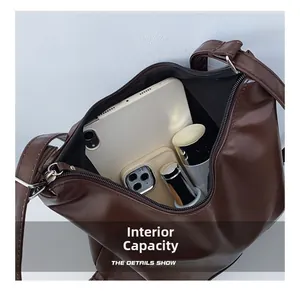 Internal capacity of the dark brown leather tote bag showing space for tablet and makeup