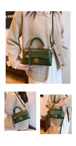 Detail view of dark green retro handbag with gold clasp and decorative bell charm