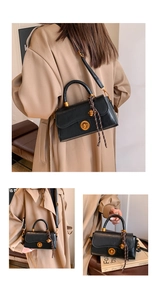 Detail of black retro handbag featuring golden twist lock and woven rope handle decoration